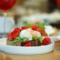 Benedict eggs with tomato and avocado