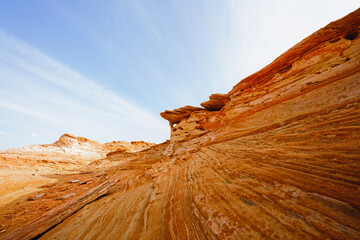 Red wavy sandstone formation of Glan Canyon National Recriation area, Page, Arizona. Bright blue sky background