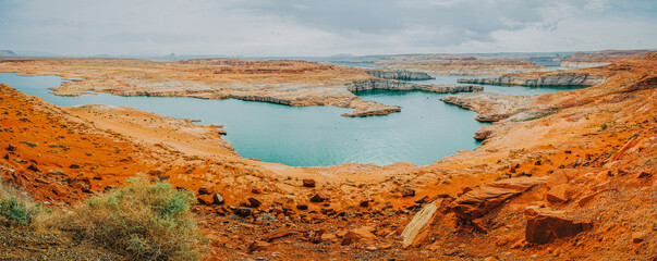 Lake Powell overlook, panorama. Red rocks, cliffs, bluffs, and cloudy sky on background