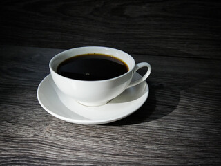 cup of hot coffee on a wooden table, morning breakfast