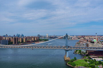 Fototapeta na wymiar Aerial view of the Manhattan bridge through the East river to district in Skyline Manhattan America.