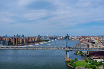 Fototapeta premium Aerial view of the Manhattan bridge through the East river to district in Skyline Manhattan America.