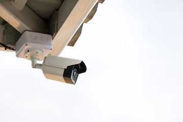 Online Security CCTV camera surveillance system outdoor of house. A blurred night city scape background. Real time Modern CCTV camera on a wall. Equipment system service for safety life or asset.