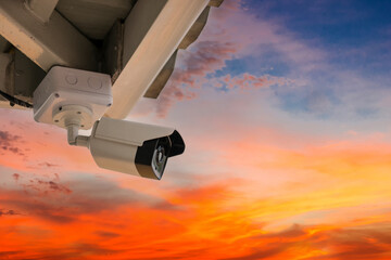 Online Security CCTV camera surveillance system outdoor of house. A blurred night city scape...