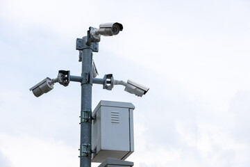 Online Security CCTV camera surveillance system outdoor of house. A blurred night city scape background. Real time Modern CCTV camera on a pole. Equipment system service for safety life or asset.