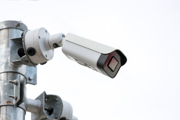 Online Security CCTV camera surveillance system outdoor of house. A blurred night city scape background. Real time Modern CCTV camera on a pole. Equipment system service for safety life or asset.