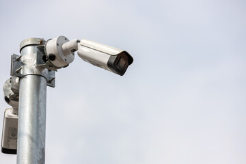 Online Security CCTV camera surveillance system outdoor of house. A blurred night city scape...