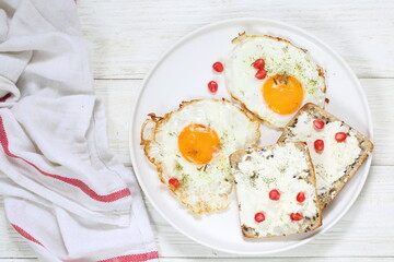 Scrambled eggs with ricotta sandwiches on white plate