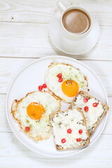 Scrambled eggs with coffee on white background