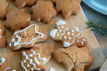 Children's hands make New Year's gingerbread cookies on a wooden table. Making cookies with a cookie cutter. New Year and Christmas concept.
