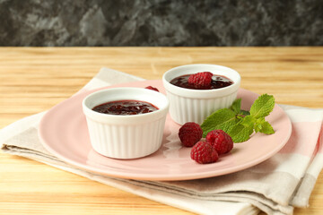 Concept of tasty food with raspberry jam on wooden table
