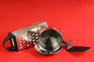 Kitchen utensil on red background, close up