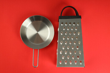 Kitchen utensil on red background, top view