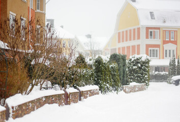 Street of the village of townhouses on a snowy winter day