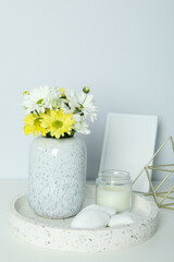 Beautiful composition with chrysanthemums and empty photo frame on white table