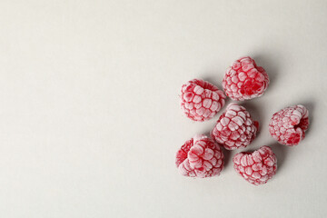 Group of frozen raspberry on light gray background