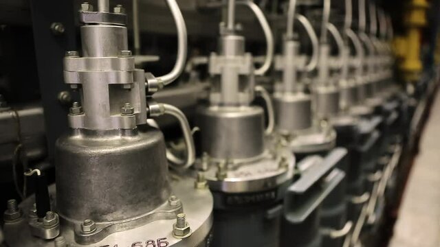 Close Up Of Gas Centrifuges For Uranium Enrichment. Upper Part Of Apparatuses Contains Steel Tubes, Bolts And Nuts. Uranium In Production Of Nuclear Fuel. Electrochemical Factory Using Uranium