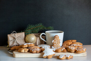 Happy New Year's set of gingerbread from ginger biscuits glazed sugar icing decoration on black background, minimal seasonal pandemic winter holiday banner