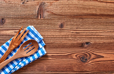 Top view of wooden fork and spoon on kitchen towel