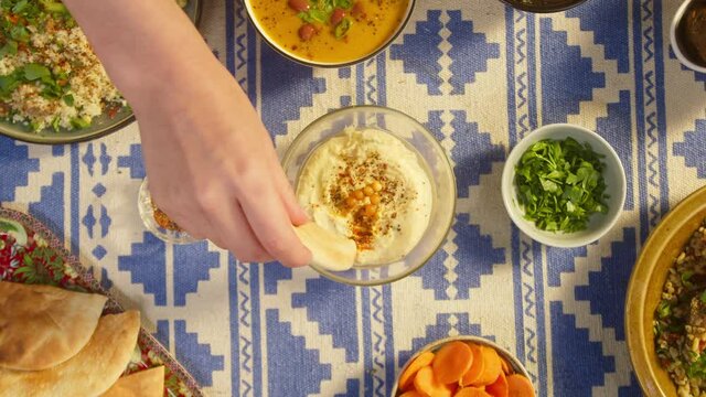 Eating pita with hummus top view, moutabal. Arabian cuisine. Bulgur with eggplant, falafel, bean soup on table, couscous with chicken. Traditional middle eastern culture. Delicious rice with meat.