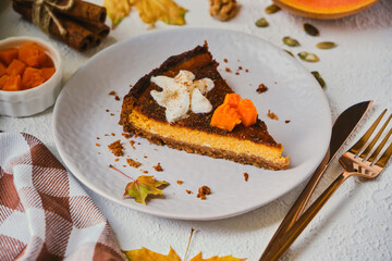 Homemade pumpkin cheesecake decorated with whipped cream.