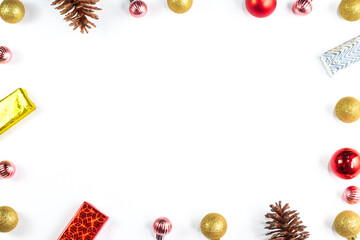 Extra wide Christmas border with fir branches, red and silver baubles, pine cones and other ornaments, isolated on white