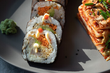Korean traditional food Kimbap rolls slices, served with Kimchi