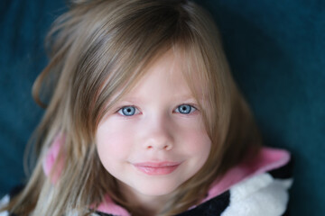 Portrait of beautiful cute little girl with blue eye