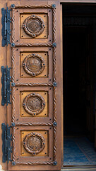 An old carved wooden door with religious motifs at the Cormaia monastery - Romania 10.Oct.2021