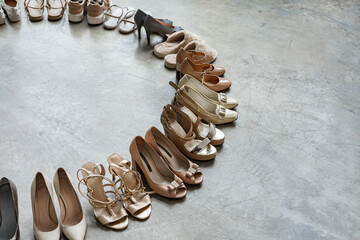 Top view many colored female shoes on gray floor footwear wheel fashion stylish footgear choosing
