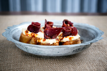 turkish traditional humus with bacon meze on copper plate