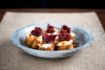 turkish traditional humus with bacon meze on copper plate