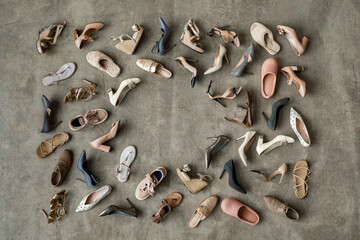 Top view many colored female shoes on gray floor ​fashion stylish footgear choosing