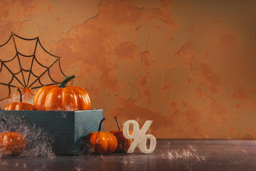 pile of orange halloween pumpkins with golden spider webs and branches. happy halloween party...