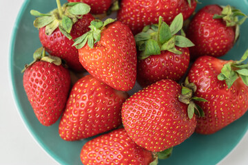 Ripe red strawberries on a plate