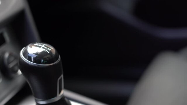 Man driver changing gears with manual transmission gear stick, close up