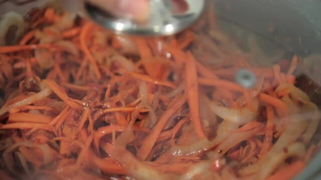 Delicious yam, carrots, tomato, and onion slices in cooking pot