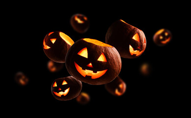 Glowing pumpkins levitate on a black background