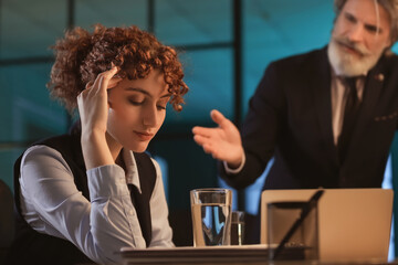 Tired businesswoman working in office at night