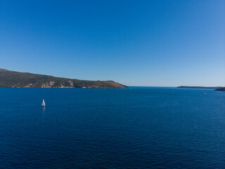 Sailing yacht sails along Bay of Kotor in Montenegro,Adriatic sea.