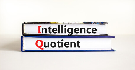 IQ intelligence quotient symbol. Concept words 'IQ intelligence quotient' on books on a beautiful white table, white background. Business, IQ intelligence quotient concept, copy space.