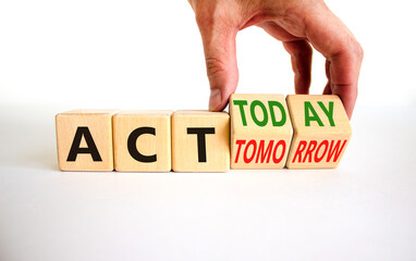 Act today not tomorrow symbol. Businessman turns wooden cubes and changes words act tomorrow to act...