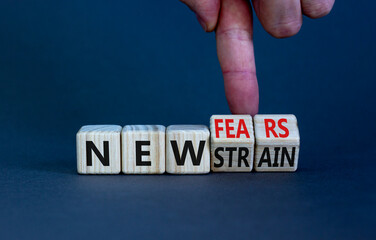 Mutated covid-19 strain virus symbol. Doctor turns cubes and changes words new strain to new fears. Beautiful grey table, grey background. Medical new mutated covid-19 strain concept. Copy space.