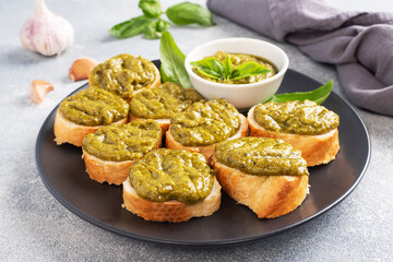 Sandwiches with pesto sauce, fresh basil leaves and garlic. A delicious healthy snack.