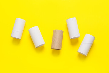 Empty toilet paper tubes on yellow background