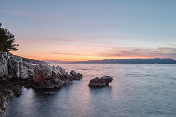 rock in adriatic sea during sunrise