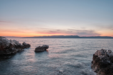 rock in adriatic sea during sunrise
