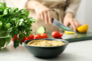 Bowl with tasty baba ghanoush on table, closeup
