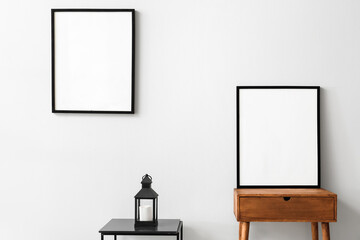Blank poster frames in light room
