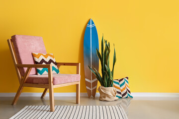 Armchair in room with stylish decor near color wall
